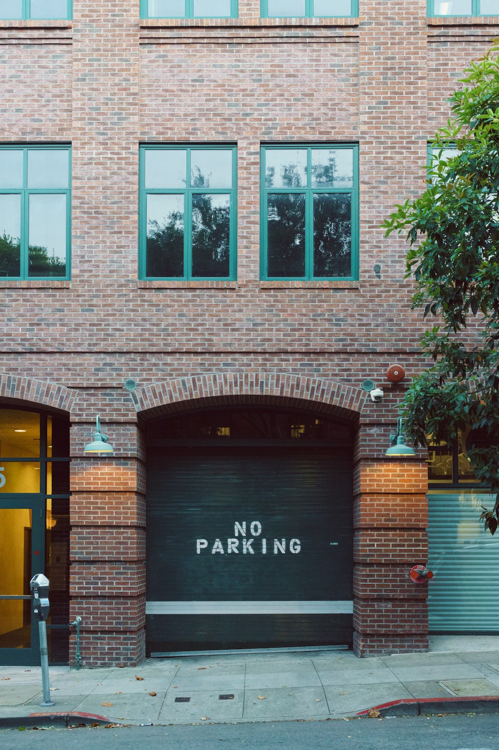 a brick building with a no parking sign on it