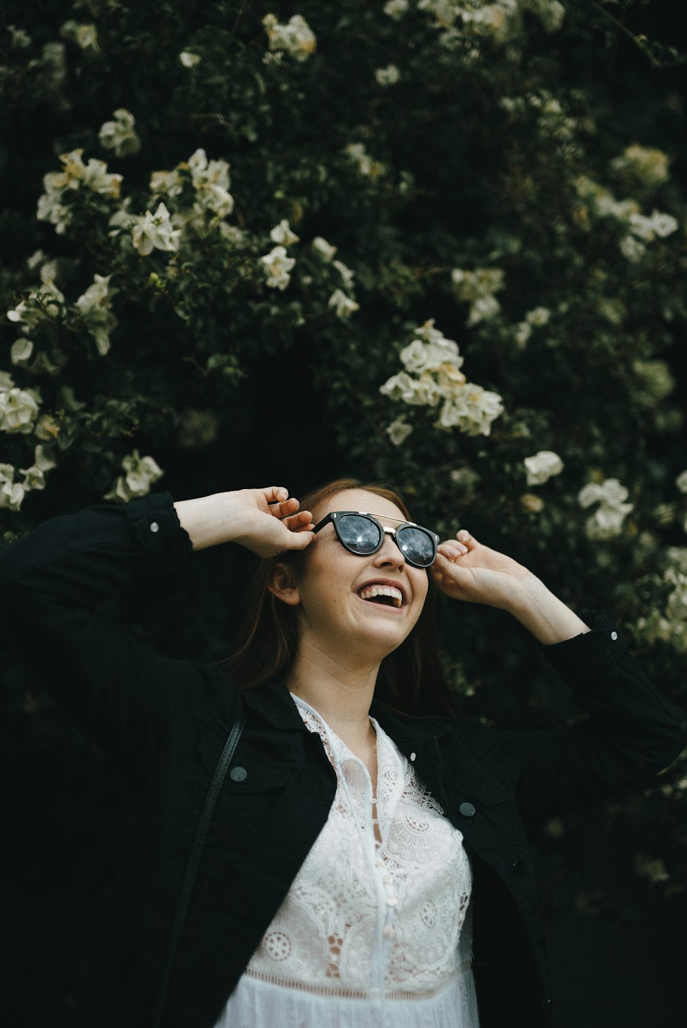 woman in black jacket wearing black sunglasses