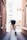 woman standing on pathway holding hat