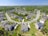 An aerial view of a suburban neighborhood highlighting well-maintained homes and green spaces.
