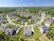 An aerial view of a suburban neighborhood highlighting well-maintained homes and green spaces.