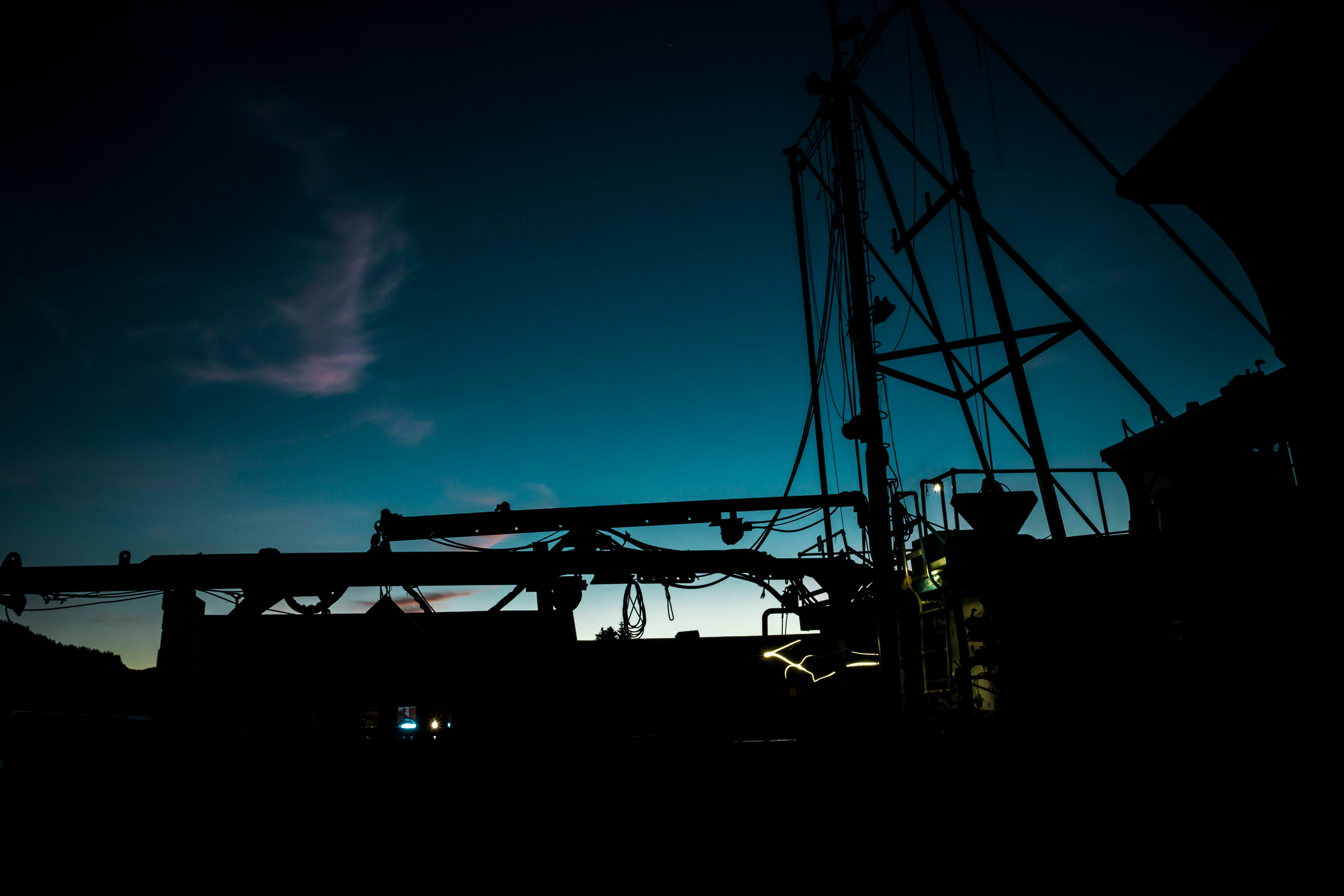 The silhouette of equipment on a boat at dusk in Hoonah