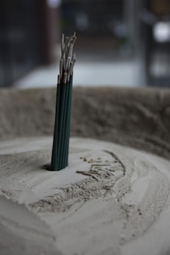 A group of happy workers showcasing finished incense products in a bright setting.