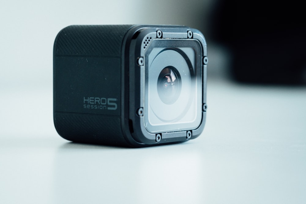 black GoPro HERO5 on white surface