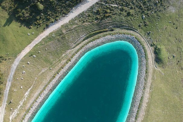 Aerial view of a turquoise lagoon surrounded by lush greenery and sandy shores