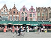 A bustling European city street filled with colorful buildings and lively cafes.