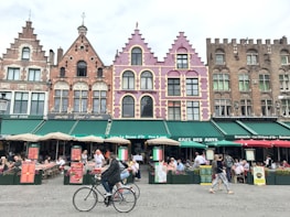 A bustling European city street filled with colorful buildings and lively cafes.