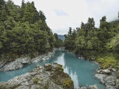 river near mountains at daytime