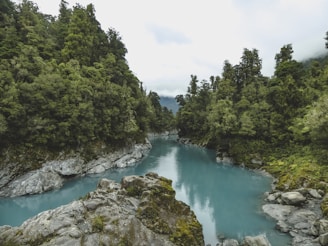 river near mountains at daytime