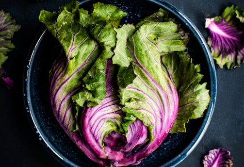 purple and green vegetable in black bowl