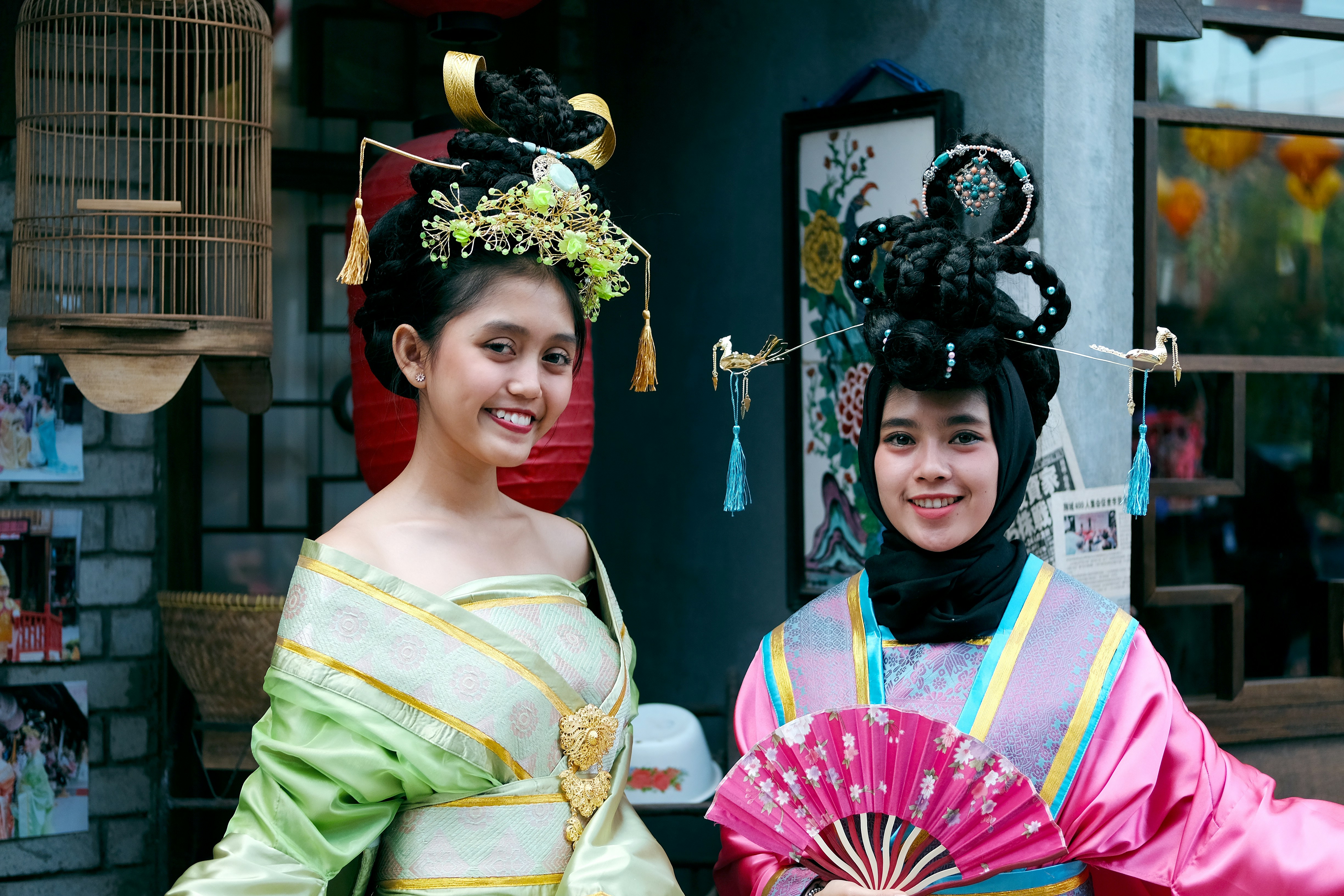 women wearing green and pink traditional dresses