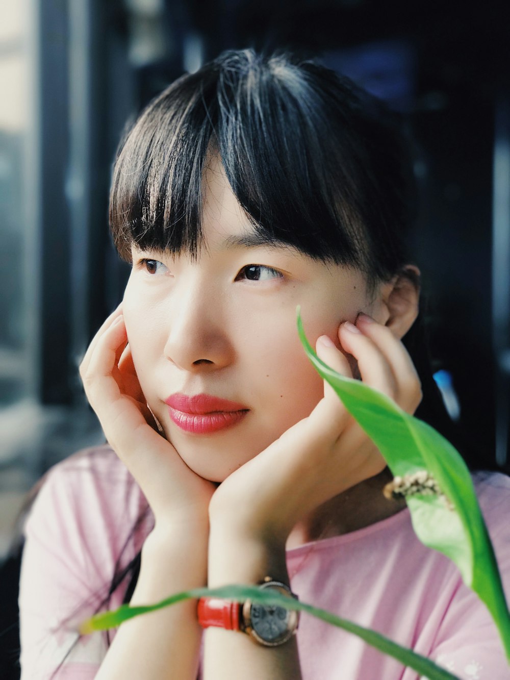 selective focus photography of woman wearing watch and pink scoop-neck shirt