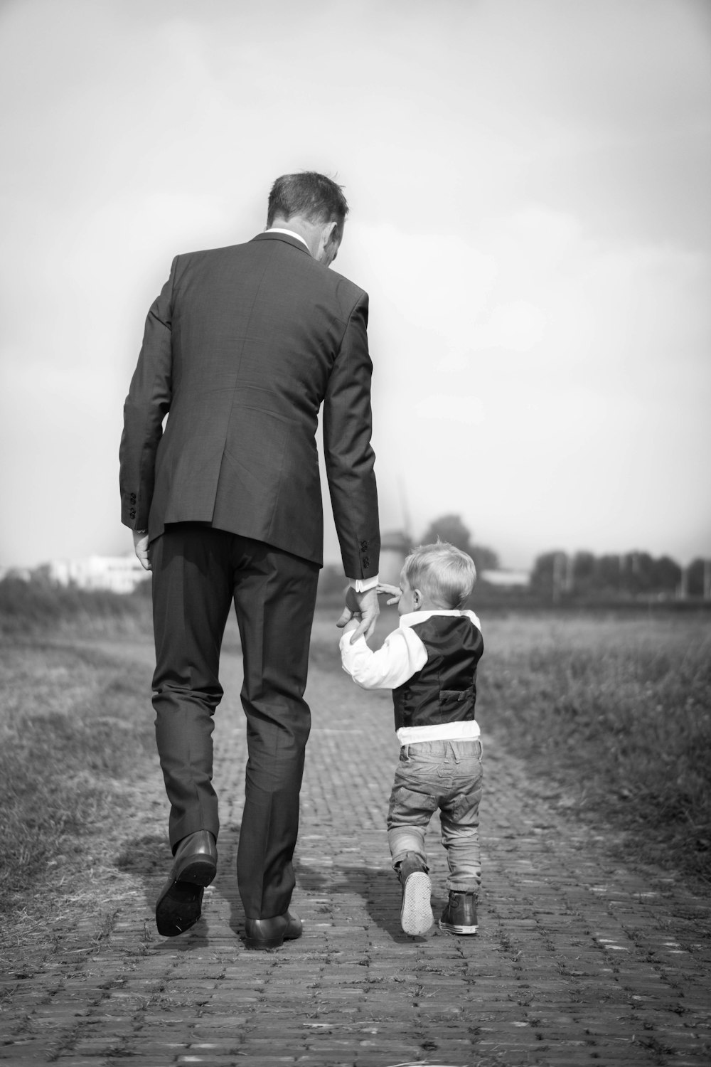 man walking holding boy