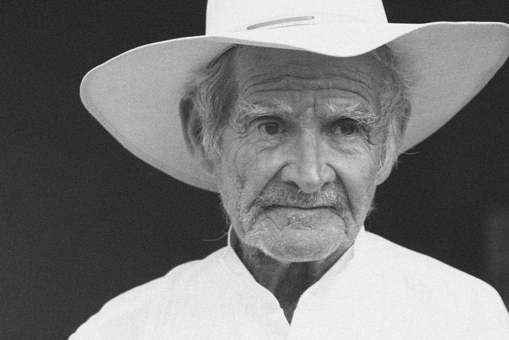 grayscale photo of man wearing sunhat