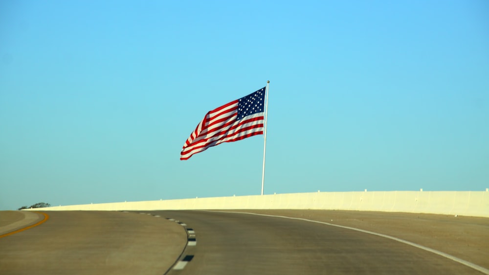 US flag beside road at daytime