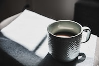 selective focus photography of mug
