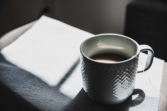 selective focus photography of mug