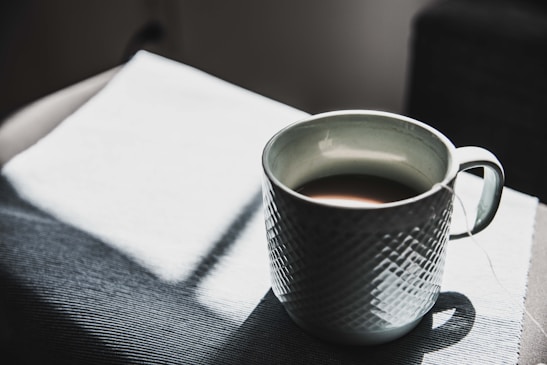 selective focus photography of mug