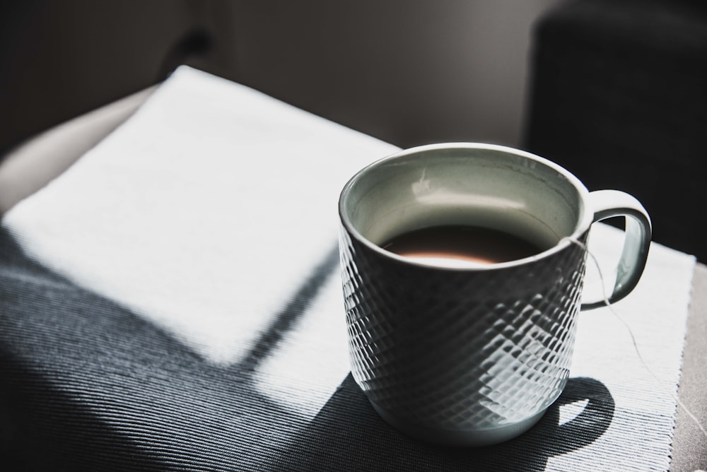 selective focus photography of mug