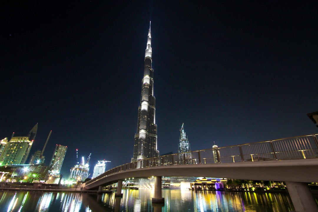 skyline photography of bridge near high-rise buildings at nighttime, A complete wonder to see and the architecture of th