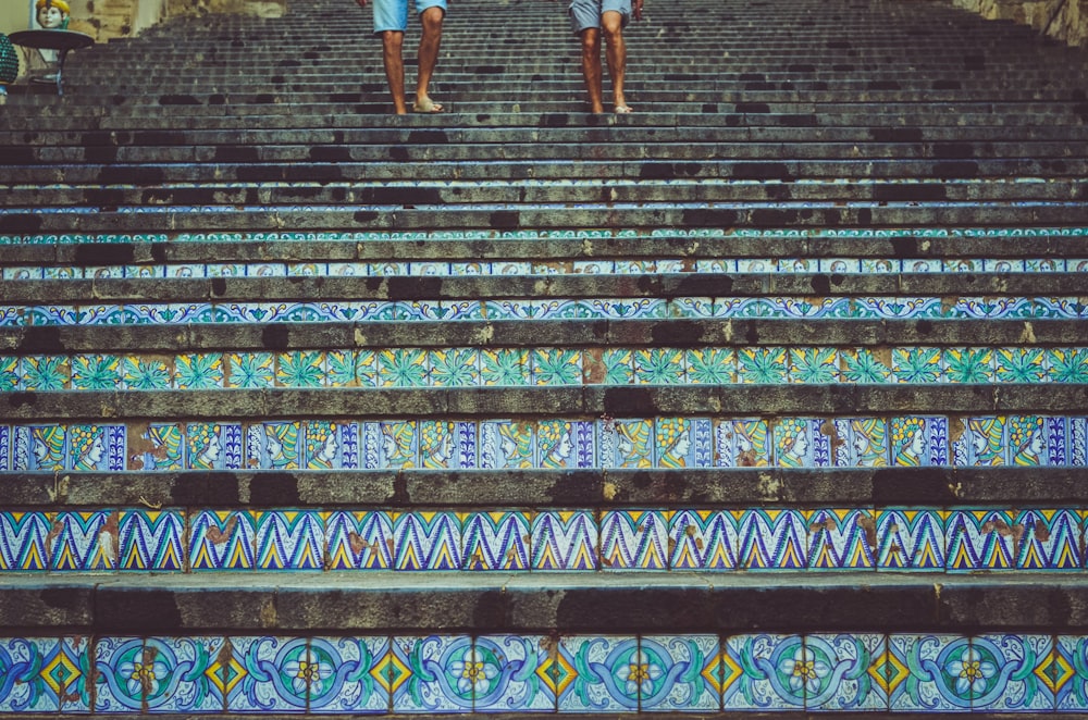 two person's stepping on stairs