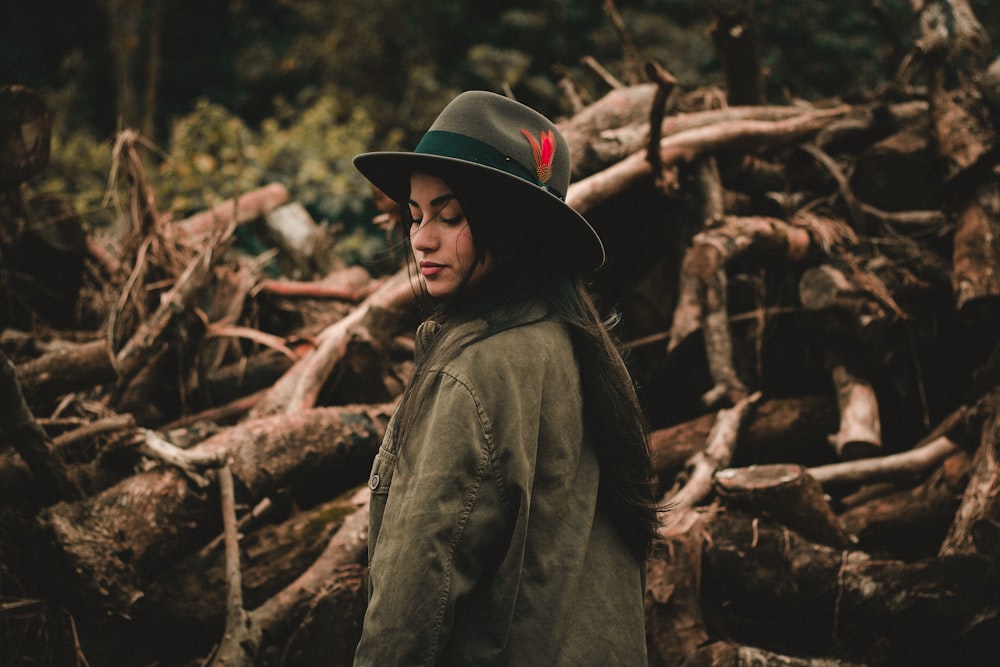 woman standing near logs