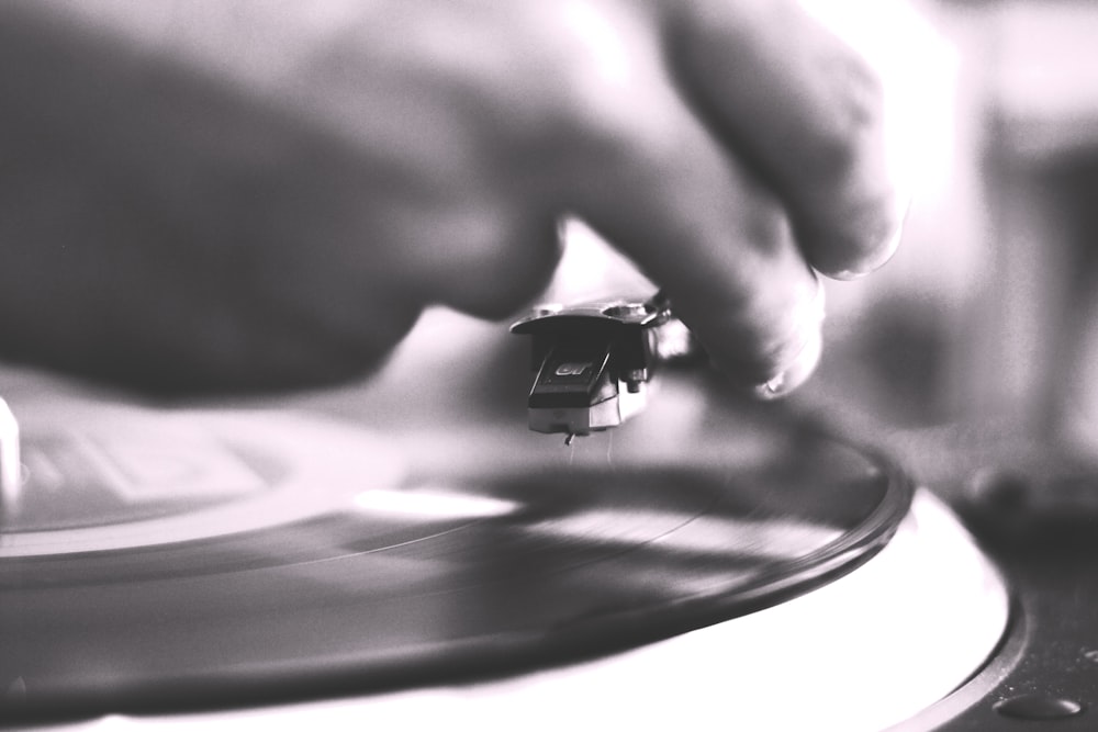 person playing vinyl record