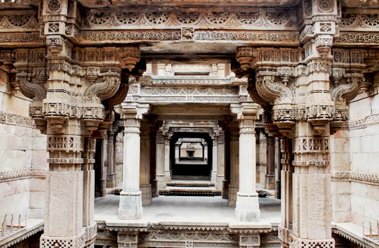 stone pillars during daytime in Adalaj Stepwell India