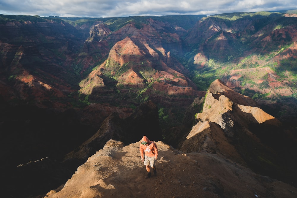 person standing on mountain during daytime