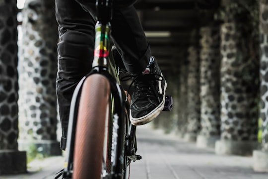 person riding bicycle on hallway in Bandung Institute of Technology Indonesia