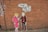 Street art on a brick wall depicting two stylized cartoon-like figures. One is a woman in a pink outfit, and the other is a man in a suit holding a speech bubble with the words 'Sydney, we need to talk!!'.