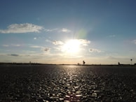 Team inspecting the quality of a newly paved road at sunset.