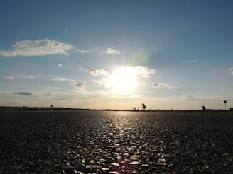 Team inspecting the quality of a newly paved road at sunset.