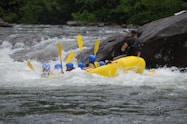 people riding on yellow kayak