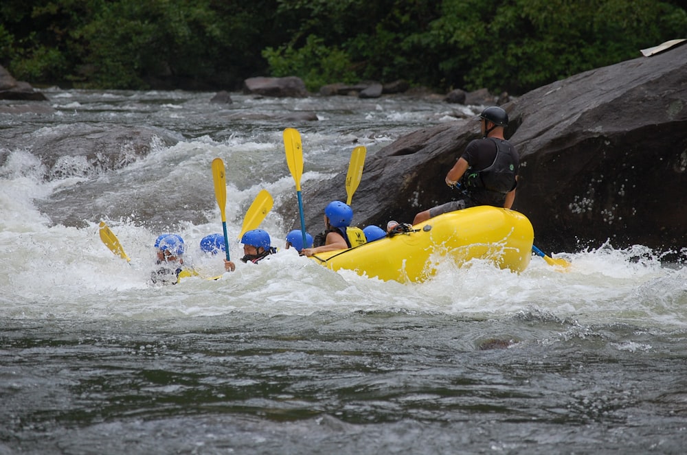 people riding on yellow kayak