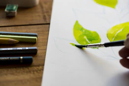 person painting leaves