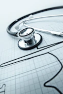 A clean, modern medical icon representing general health consultation with a stethoscope.