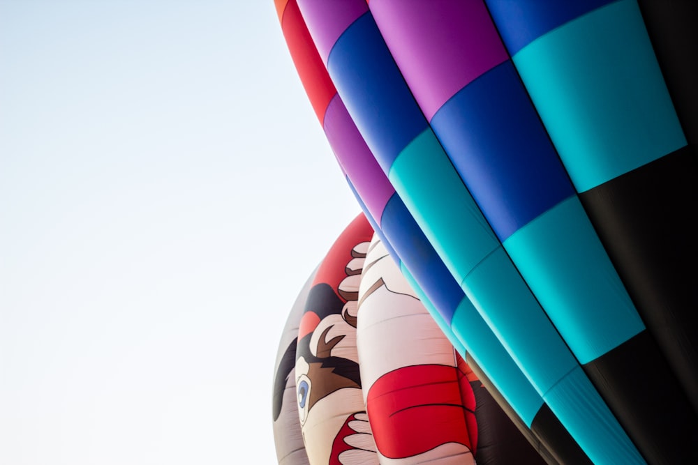 a group of colorful hot air balloons flying in the sky