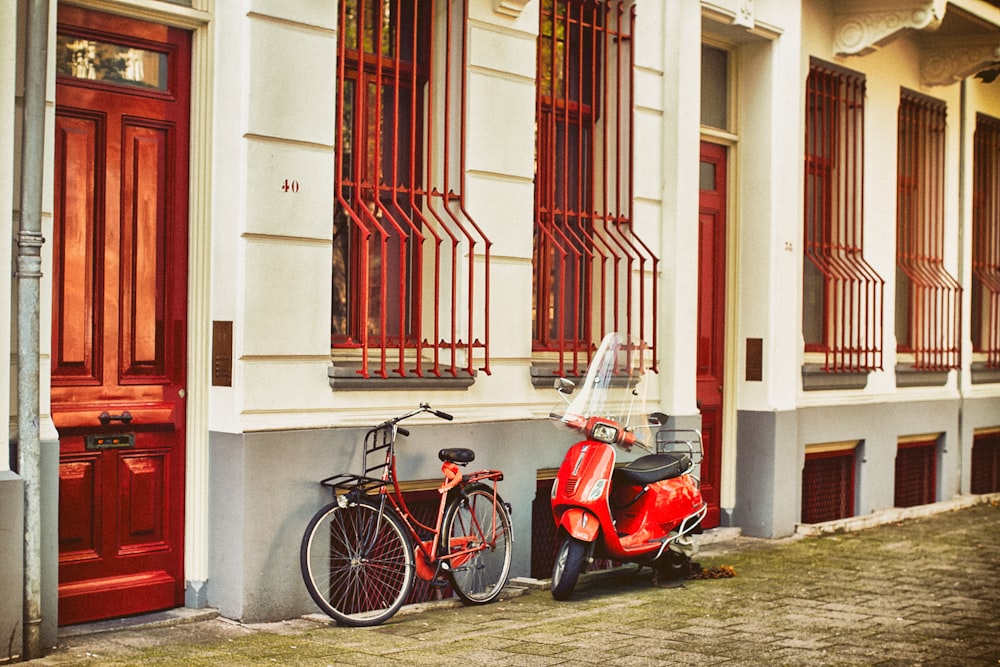 red motor scooter parked beside house