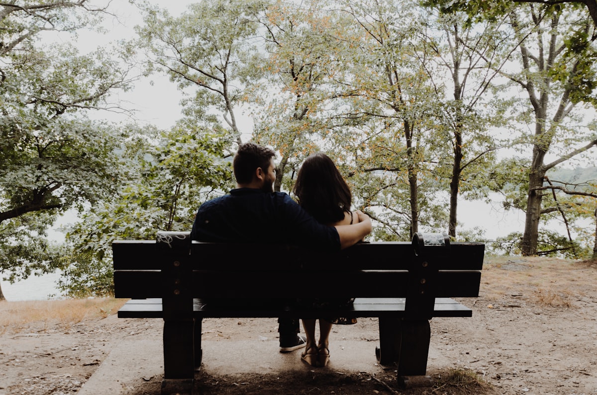 A young couple in love sitting close together
