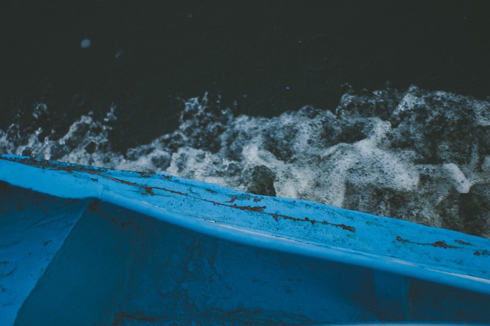 blue boat on body of water