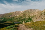 A scenic mountain landscape with a winding trail.