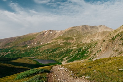 A scenic mountain landscape with a winding trail.
