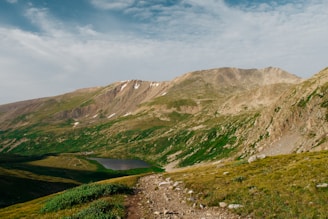 A scenic mountain landscape with a winding trail.