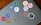 A laptop is adorned with various hexagonal stickers featuring different programming languages and tools, such as PHP, Python, JavaScript, HTML, CSS, Git, and others. The central logo on the laptop is from Dell.