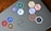 A laptop is adorned with various hexagonal stickers featuring different programming languages and tools, such as PHP, Python, JavaScript, HTML, CSS, Git, and others. The central logo on the laptop is from Dell.
