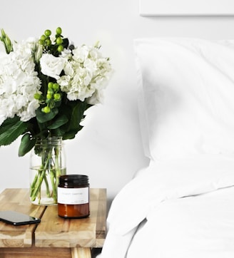 flowers in clear glass vase on table