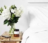 flowers in clear glass vase on table