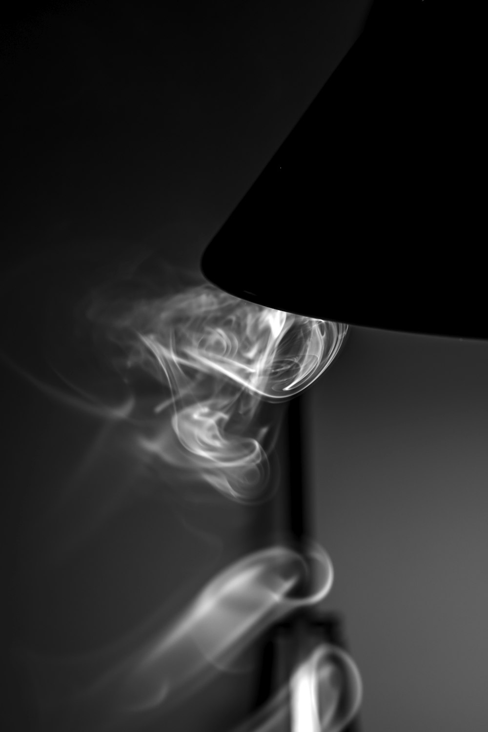 a black lamp with smoke coming out of it