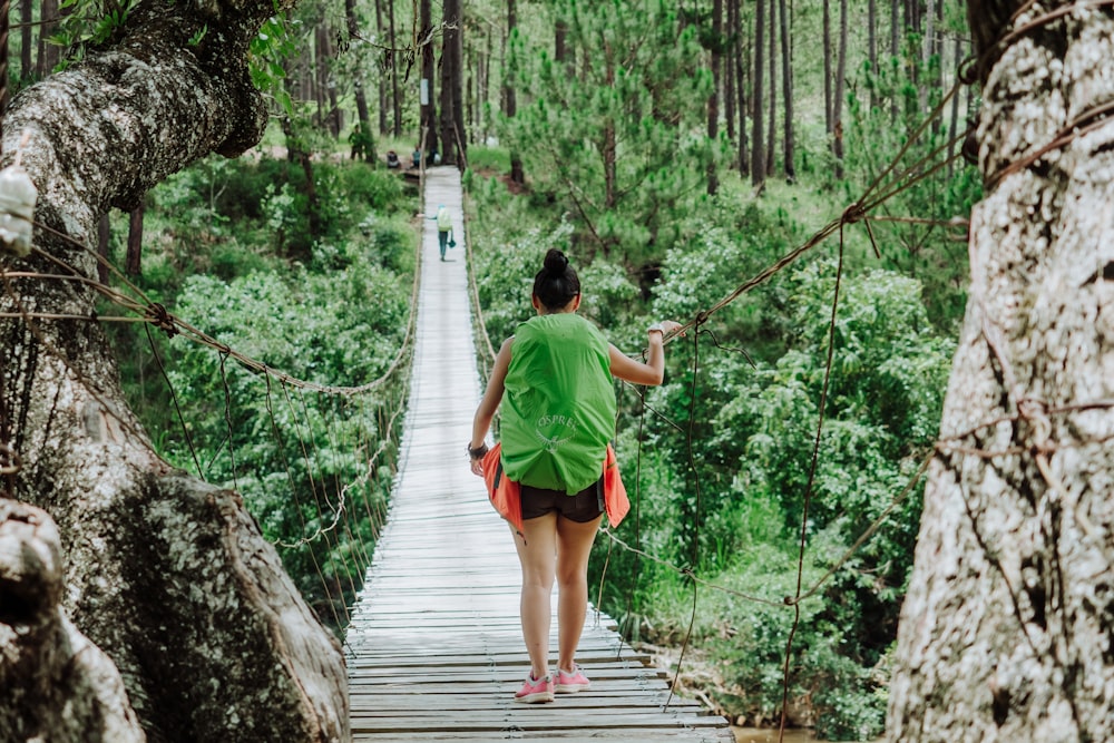 selective focus photography of woman on bridge